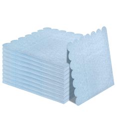 a stack of blue napkins with scalloped edges