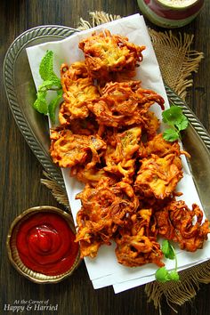 some fried food is on a plate with ketchup