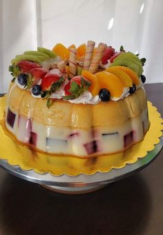 a cake with fruit on top is sitting on a table