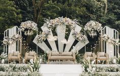 an outdoor wedding setup with chairs and flowers