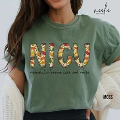 a woman wearing a green t - shirt with the word nicu printed on it