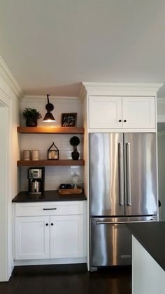 a kitchen with white cabinets and stainless steel appliances