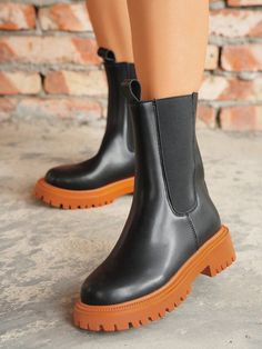 Upgrade your shoe game with Urban Chic's Women's Dopamine Sole Chelsea Boots. These stylish and durable boots feature a unique sole design that provides increased comfort and support for your feet. Expertly crafted with high-quality materials, these boots are perfect for any fashion-forward woman looking to make a statement while staying comfortable. Color : Orange Closure Type : Back Zipper Insole Material : Polyester Lining Material : Polyester Outsole Material : PVC Upper Material : PU Leathe Casual High Ankle Boots In Polyurethane, Trendy Outdoor Boots With Rubber Sole, Casual High Ankle Platform Boots With Textured Sole, Trendy High Ankle Martin Boots With Rubber Sole, Trendy Platform Boots With Round Toe For Outdoor, Trendy Outdoor Platform Boots With Round Toe, Casual Platform Boots With Lug Sole, Outdoor Platform Boots With Reinforced Heel And Round Toe, High Ankle Boots With Lug Sole In Polyurethane