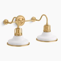 three light bathroom fixture with white glass shades and gold metal fittings on the arms