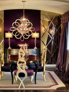 an elegant dining room with chandelier and purple chairs in front of the table