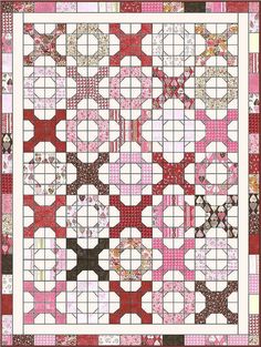 a pink and brown quilt with white circles on the center, in front of a red background