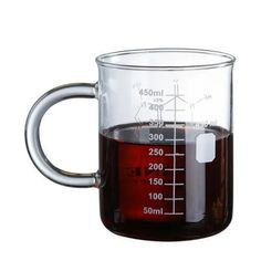 a measuring cup filled with liquid on top of a table