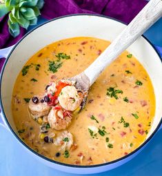 a white bowl filled with soup and shrimp