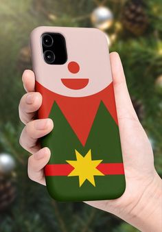 a person holding up a phone case with a christmas decoration on it