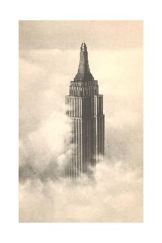 the empire building towering above the clouds in new york city