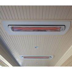 an air conditioner mounted on the side of a wall next to a ceiling fan