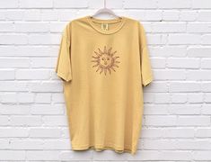 Please read description before purchasing. 100% cotton. Super cute Comfort Colors brand t-shirt with a sun design. Printed with water-based ink. Model is wearing size L in White and Yam colors, and M in Mustard color for an oversized look. Please note, for an oversized look, we suggest to size up 1-3 sizes depending on how oversized you would like it. These shirts run like standard unisex tees. Please see size chart. We are hooked on the soft vintage feel of Comfort Colors brand shirts and we kn Casual Short Sleeve T-shirt For Summer, Relaxed Fit Short Sleeve Top For Warm Weather, Yellow Soft-washed Relaxed Fit T-shirt, Yellow Relaxed Fit Soft-washed T-shirt, Cotton Tops For Warm Weather, Casual Crew Neck T-shirt For Warm Weather, Warm Weather Crew Neck Cotton Top, Crew Neck Cotton Top For Warm Weather, Warm Weather Cotton Crew Neck Top