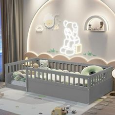 a baby's room with a crib and teddy bears on the wall in it