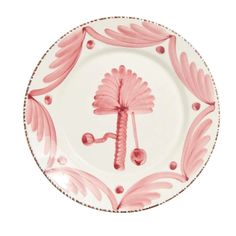 a pink and white plate with designs on it