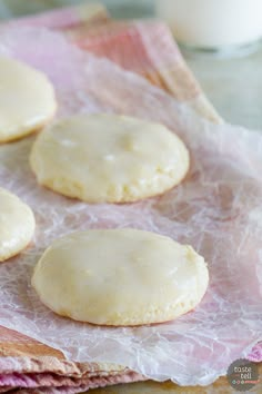 four cookies are sitting on wax paper and ready to be baked in the oven,