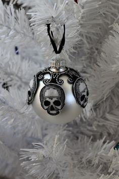 an ornament hanging from the christmas tree with a skull and crossbones on it