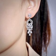 A delightfully unique pair of bridal earrings with an incredible sparkle! Lightweight, the earrings are adorned with flawlessly faceted cubic zirconia that capture the light in a dazzling array of sparkles, and are rhodium plated for a bright finish which enhances the intricate detailing and conveys a modern take on old elegance. Length: 1.25" (approx. 3.2cm). Hypoallergenic - lead, nickel and cadmium free. This exquisite design will add a touch of sophistication to any wedding gown or formal en Unique Wedding Earrings, Cubic Zirconia Bridal Earrings, Long Bridal Earrings, Earrings Prom, Silver Bridal Earrings, Bridal Statement Earrings, Lavender Earrings, Silver Crystal Earrings, Bridesmaids Earrings