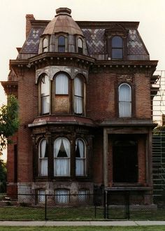 an old victorian house is shown in black and white