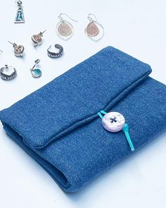 a blue cloth with buttons and earrings on it