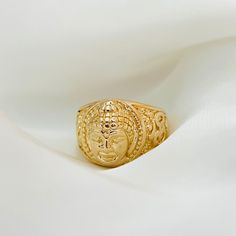 A must have for those who love meditation and spiritualism. This gold signet ring is designed with a three-dimensional, Buddha face that is certain to leave you making a statement. The chunky gold band provides extra support and durability to the piece, making it a perfect gift for those who love Buddhism and Hinduism.   ⭐️Item Details:  Ring Height: 14.5mm Band Width: 3mm Benefits: Water & Tarnish Resistant, Hypoallergenic  ⭐️Care Instructions:  1. You may shower and sleep with your gold filled Spiritual Yellow Gold Signet Ring, Spiritual Yellow Gold Signet Ring Gift, Yellow Gold Open Signet Ring In Spiritual Style, Gold Adjustable Engraved Spiritual Ring, Adjustable Gold Engraved Spiritual Ring, Gold Spiritual Signet Ring For Gift, Gold Spiritual Signet Ring As A Gift, Love Meditation, Gold Buddha