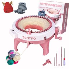 the knitting machine is pink and white with red trimmings next to it's contents