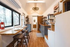 a kitchen with wooden floors and white walls