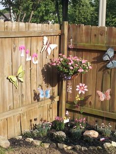 a wooden fence with flowers and butterflies on it