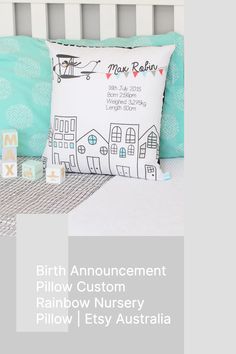 the birth announcement pillow is displayed in front of a bed with blue and white pillows