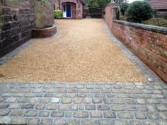 a brick walkway leading to a blue door