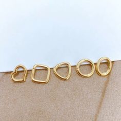 We are a customised jewellery store and we do not normally hold stock. We aim to dispatch your jewellery within 2-3 weeks of ordering. Please DO NOT order if you need this piece urgently.  Material: 18K solid gold, G18K/AU750 hallmarked. Sizes: all sizes below are hand measured, please expect slight variances.  Oval: 7.5mm*9mm, thickness 1.4mm  Square: 9mm*9mm,thickness 1.4mm Heart: 8.2mm*9.2mm, thickness 1.4mm  Circle: 9.1mm, thickness 1.4mm Triangle: 9mm, thickness 1.4mm These enhancer connect Stackable White Gold Huggie Earrings, White Gold Stackable Huggie Jewelry, Minimalist Metal Huggie Jewelry, Minimalist Gold Huggie Jewelry, Stackable Yellow Gold Huggie Earrings As Gift, Yellow Gold Metal Huggie Earrings Gift, Yellow Gold Hoop Jewelry Gift, Yellow Gold Hoop Jewelry As Gift, Gold Polished Huggie Earrings For Gift