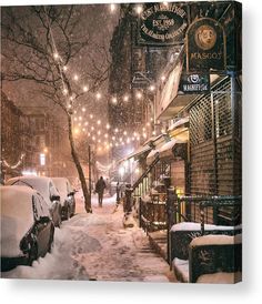 a city street covered in snow with cars parked on the side and people walking down the sidewalk