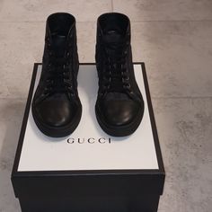 Gucci Sneakers Solid Black Shoe Black Insole, Black Bottom Sole With "Gucci" Logo Along With Imprinted Palm Tree Black Laces Leather At The Toe And Threading Of The Shoe Nylon Threading Gucci Lace-up Calf Leather Sneakers, Designer Black Sneakers With Rubber Heel Cap, Black Calf Leather High-top Sneakers With Round Toe, Gucci Lace-up High-top Sneakers With Rubber Sole, Luxury Gucci High-top Sneakers With Contrast Sole, Gucci High-top Sneakers With Contrast Sole, Gucci High-top Sneakers With Contrast Sole And Round Toe, Black Sporty Gucci High-top Sneakers, Black Low-top Calf Leather Boots