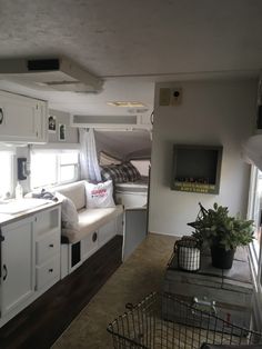 the interior of a camper is clean and ready to be used as a living area