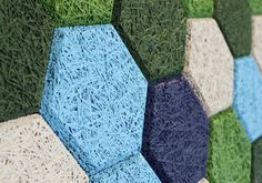 a wall made out of artificial grass with blue and green colors