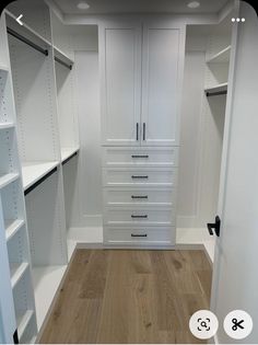 an empty walk in closet with white drawers