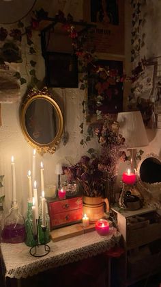 there are many candles on the table in front of the mirror and other things around it