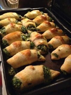 a pan filled with spinach and cheese pastries