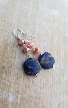 Sodalite Earrings Sterling Silver, Blue and Orange Earrings, Carnelian Earrings, Square Shaped Gemstone Dangle Earrings, Sunset Sodalite Dark indigo blue and orange sunset sodalite gemstones displaying lovely patterns dangle from mystic coated carnelian gemstones and sterling silver ear wires. The total length of the earrings is approximately 2 inches. The square orange sodalite gemstones are about 1/2 inch wide and 1/2 inch tall. They are faceted and polished on both sides. The blue and orange Spiritual Agate Gemstone Earrings, Agate Gemstone Dangle Earrings, Agate Gemstone Bead Dangle Earrings, Agate Dangle Earrings With Ear Wire, Agate Natural Stone Dangle Earrings, Natural Stone Agate Dangle Earrings, Agate Gemstone Drop Earrings, Agate Dangle Earrings With Natural Stones, Dangle Earrings With Natural Agate Stones