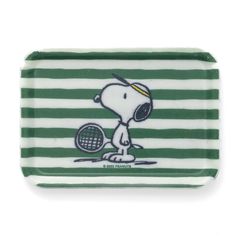 a green and white tray with a cartoon character holding a tennis racquet on it