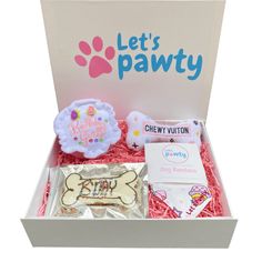 an open box with cookies and treats in it that says let's pawty