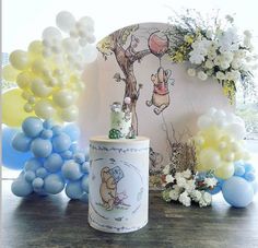 a winnie the pooh birthday party with balloons and decorations