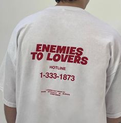 the back of a man's white shirt that says, enemes to lovers