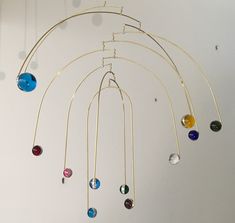 a wind chime with multicolored glass balls hanging from it