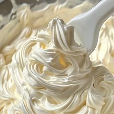 whipped cream in a bowl with a spoon