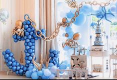 blue balloons are arranged in the shape of an eiffel tower on display at a birthday party