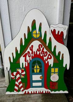 a cardboard house with candy canes on the front door