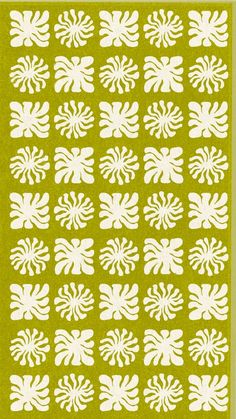 a green rug with white flowers on the front and back of it, in an abstract pattern