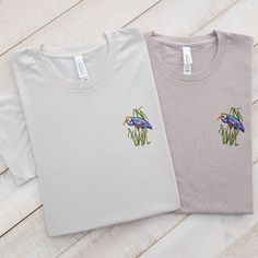 Discover the Elegance and Comfort of Our Embroidered Blue Heron T-Shirt! Elevate your style with our handcrafted, unisex t-shirts, showcasing a gracefully embroidered blue heron. Ideal for any season, these tees merge fashion with function, making them a quintessential pick for daily wear. Each piece is constructed from premium materials, ensuring enduring quality and a gentle feel. Discover More Options: Love this design? We offer it in additional apparel options that might catch your eye:  Swe Cotton T-shirt With Machine Embroidery, Relaxed Fit, Short Sleeve Cotton Top With Machine Embroidery, Casual Relaxed Fit T-shirt With Machine Embroidery, Cotton Top With Machine Embroidery, Short Sleeve, Basic Embroidered Short Sleeve T-shirt, Basic Relaxed Fit Top With Custom Embroidery, Basic Cotton Tops With Custom Embroidery And Relaxed Fit, Basic Embroidered Short Sleeve Tops, Spring Crew Neck T-shirt With Machine Embroidery