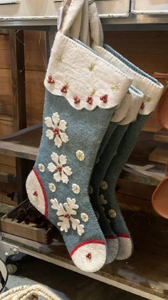 two christmas stockings hanging from hooks in a shop