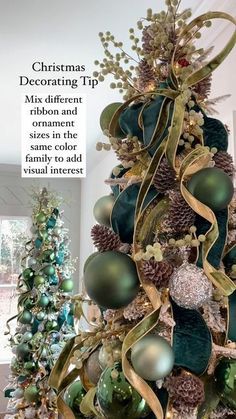 a christmas tree is decorated with green and gold balls, ornaments, and ribbons in an elegant manner